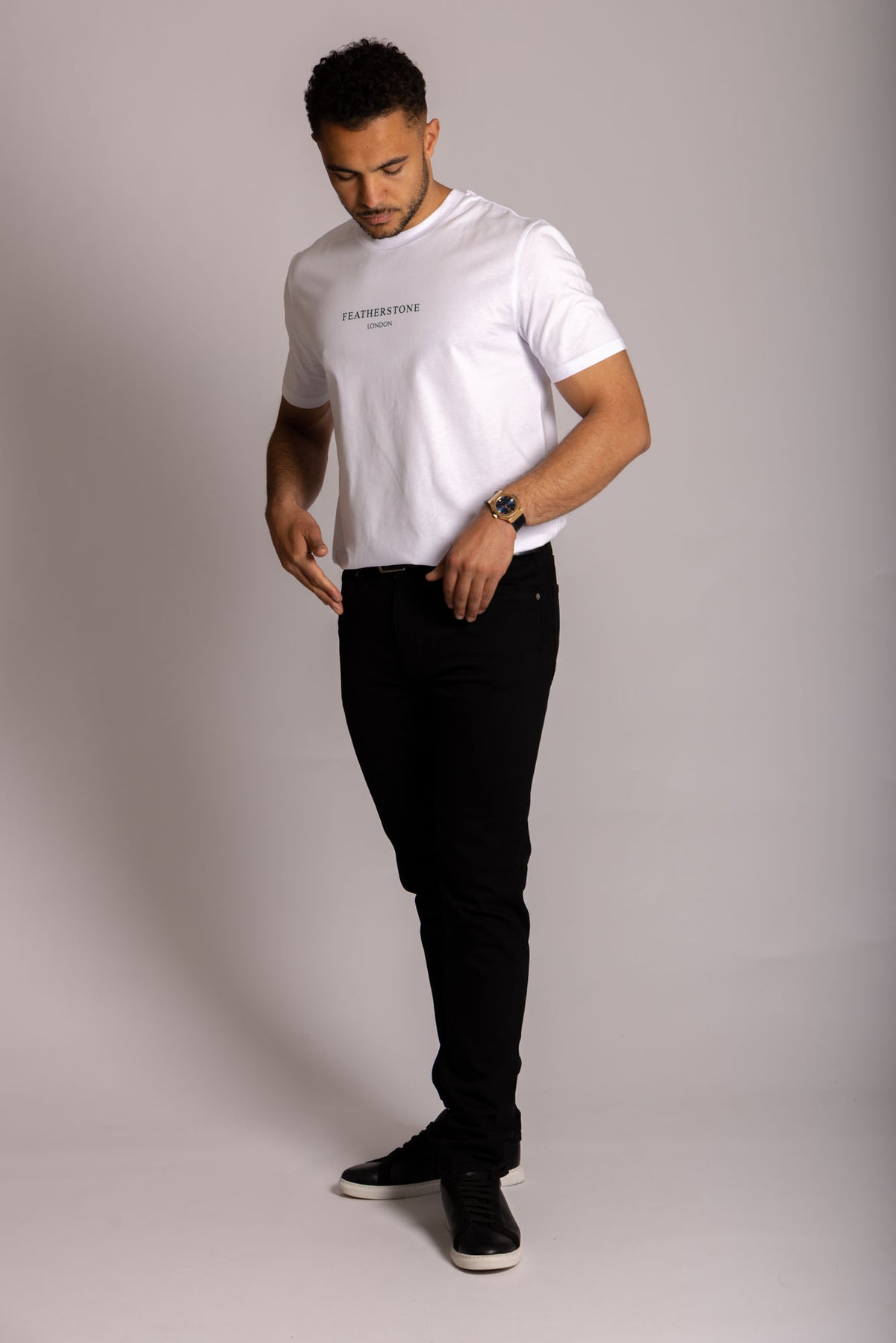 Men’s white logo T-shirt – crew neck short sleeve by Featherstone London - Casual Pose