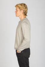 Side view of ash beige wool long sleeve jumper with embroidered logo