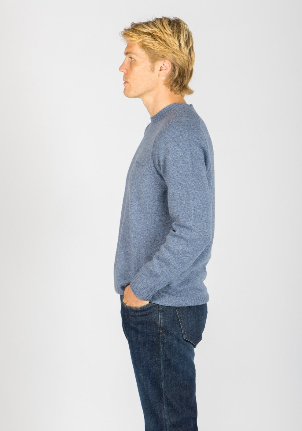 Side view of sky blue wool crew neck jumper with embroidered logo
