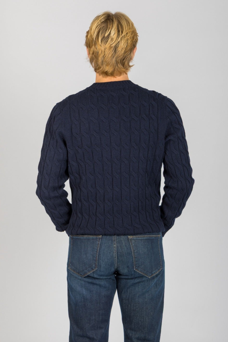 Back view of navy wool-cashmere blend cable knit jumper with ribbed hem