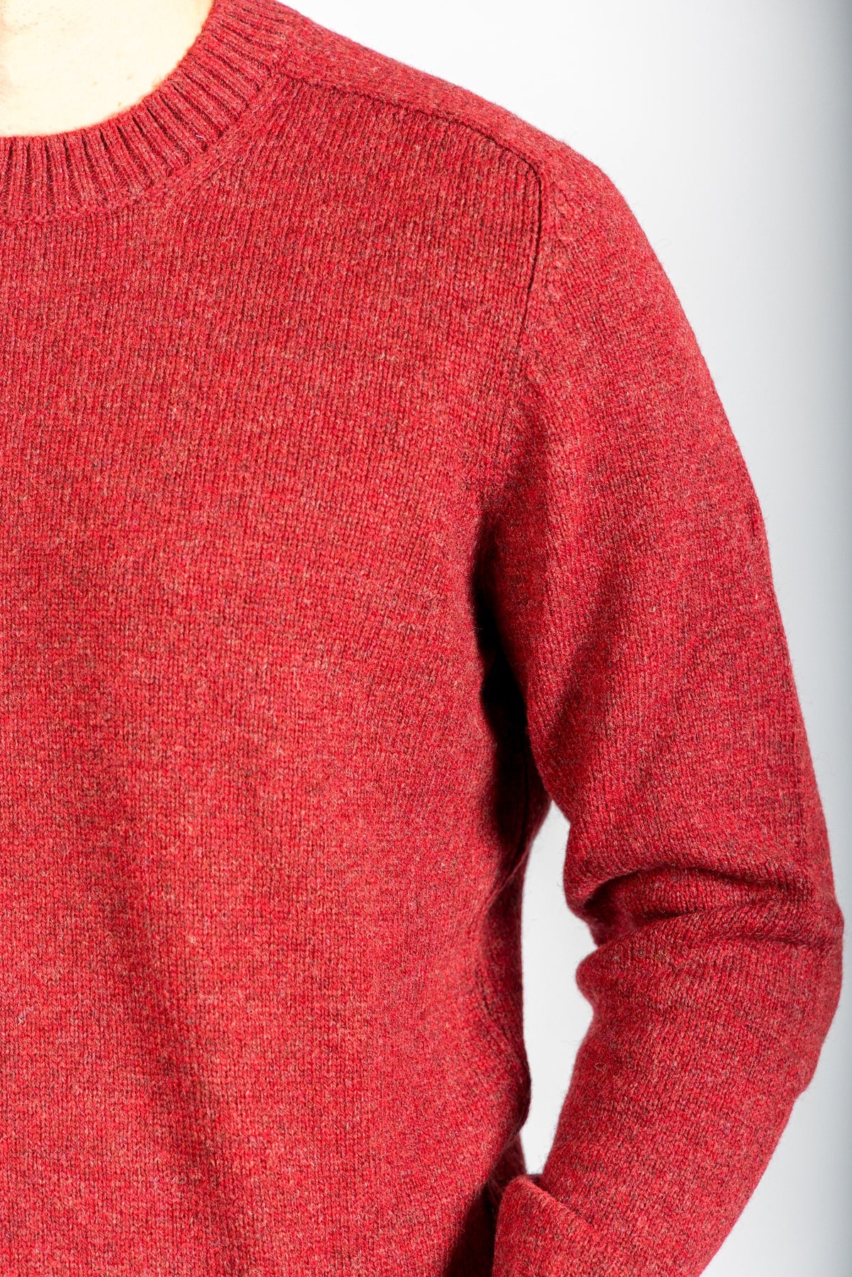 Close-up of red marl knit texture on wool jumper