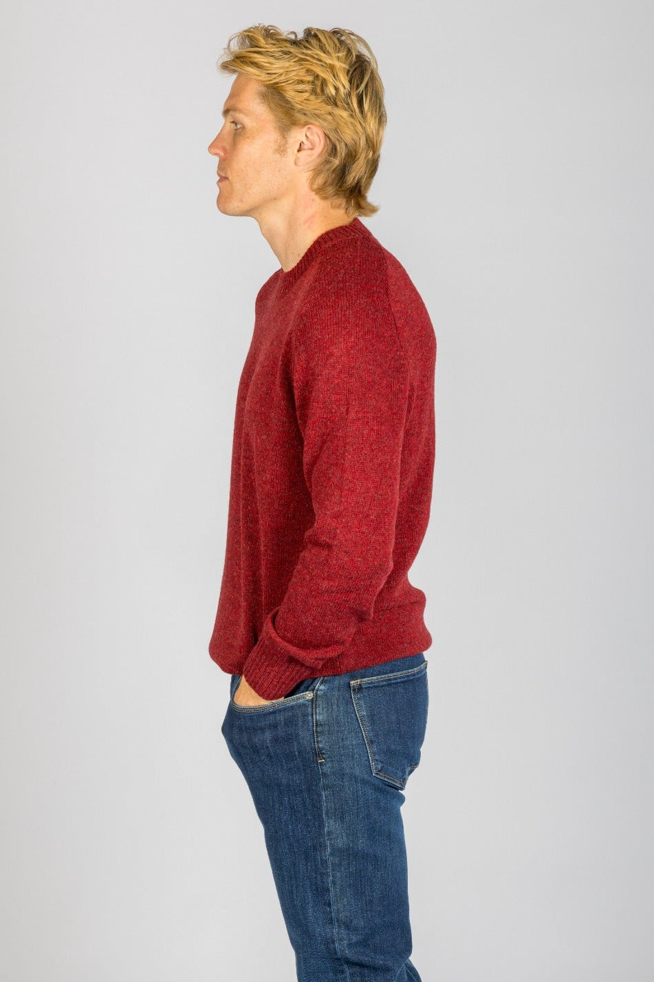 Side view of red marl wool crew neck jumper