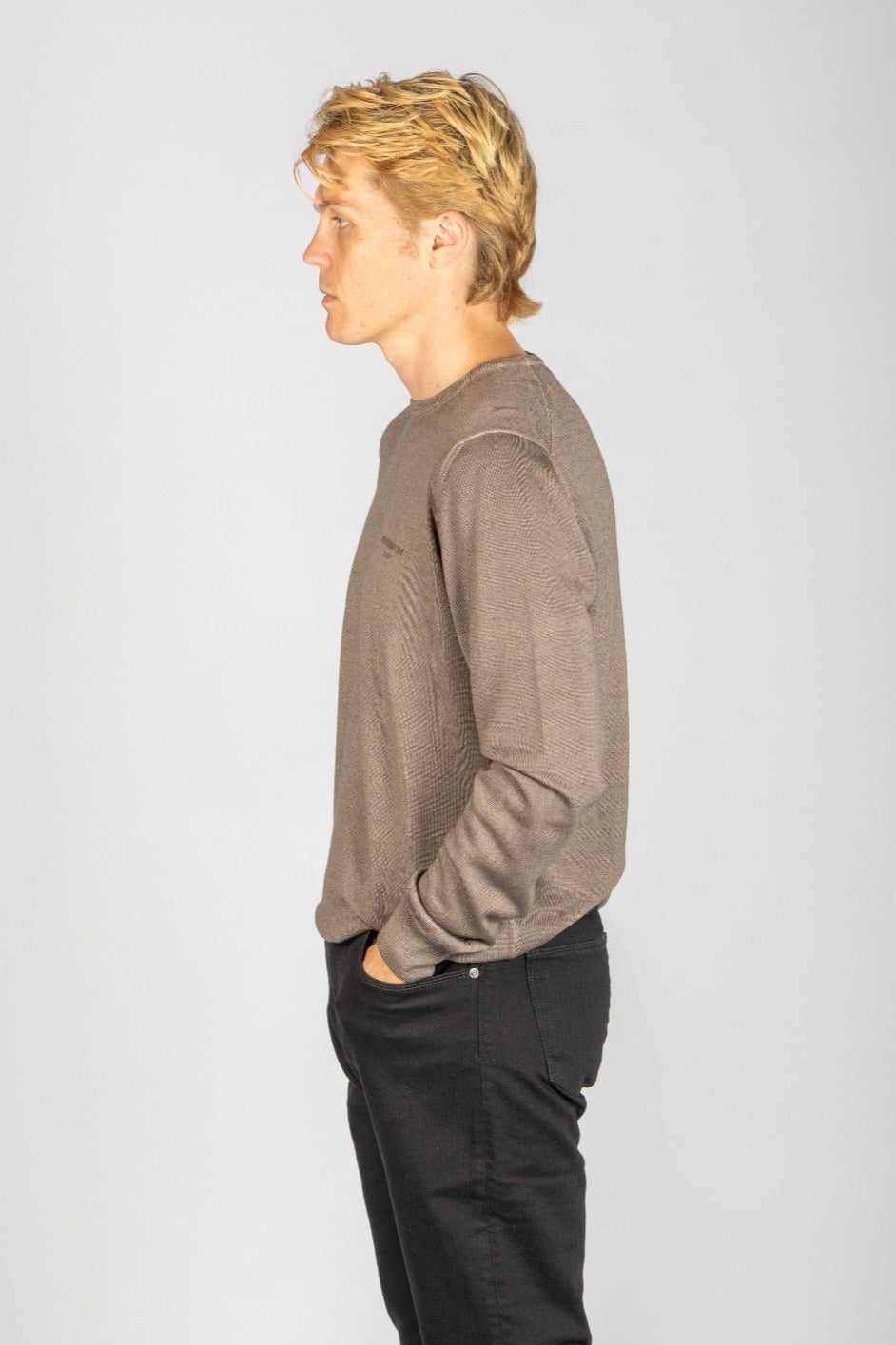 Side profile of taupe wool long sleeve jumper with embroidered logo