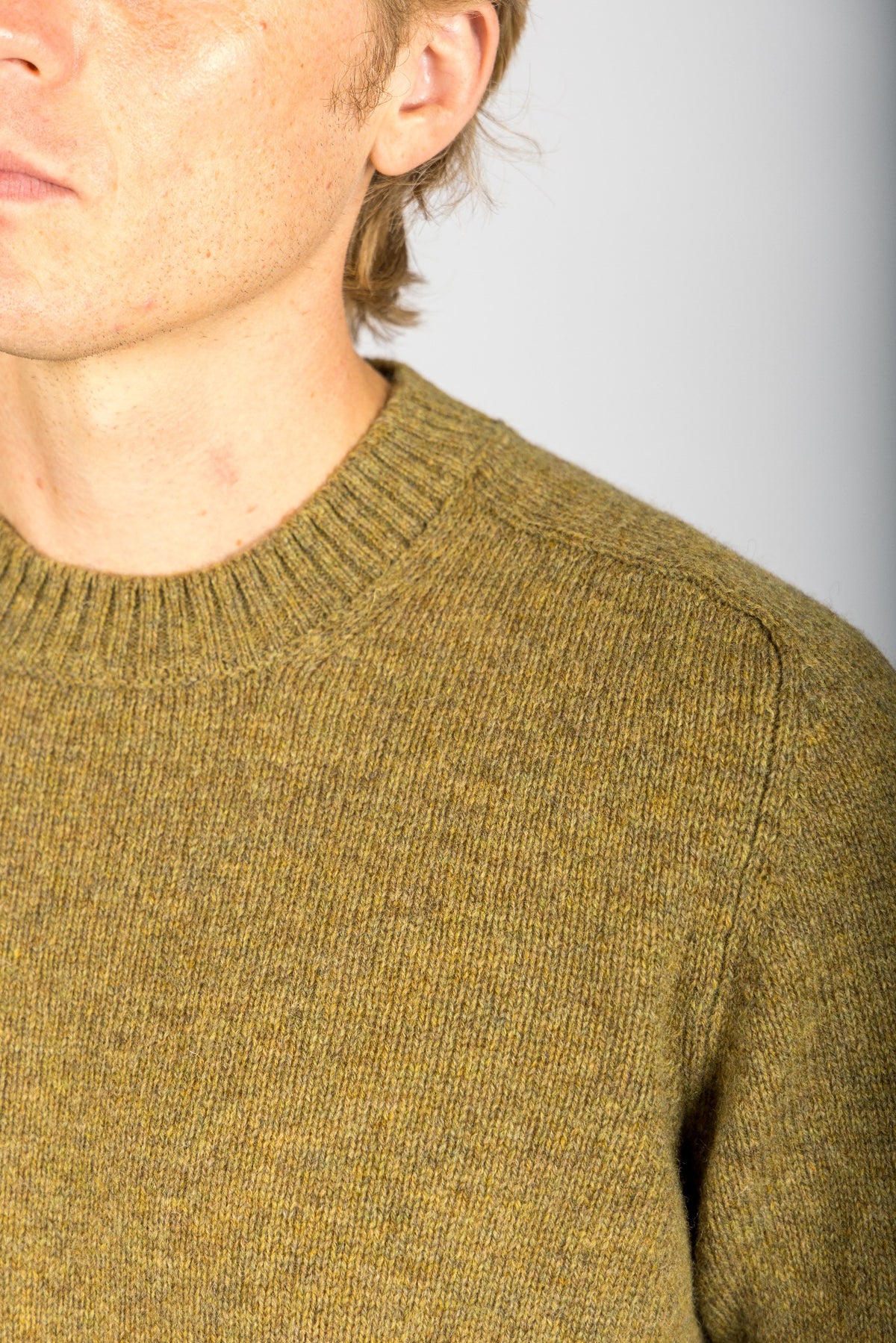 Close-up of moss marl knit texture on wool jumper