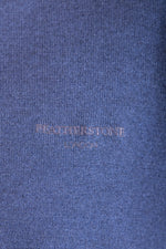 Close-up of embroidered logo on navy wool crew neck jumper