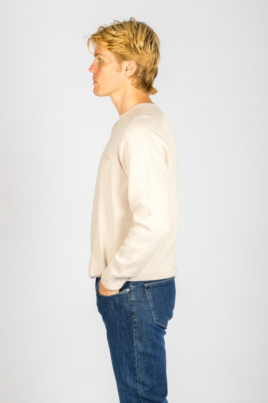 Side profile of oatmeal marl wool crew neck jumper with embroidered logo